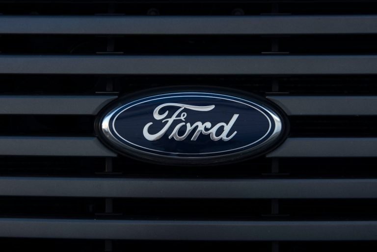 The Advantages of Buying a Ford Car – Ultimate Guide A sleek Ford car parked in a scenic location, representing the advantages of owning a Ford vehicle.