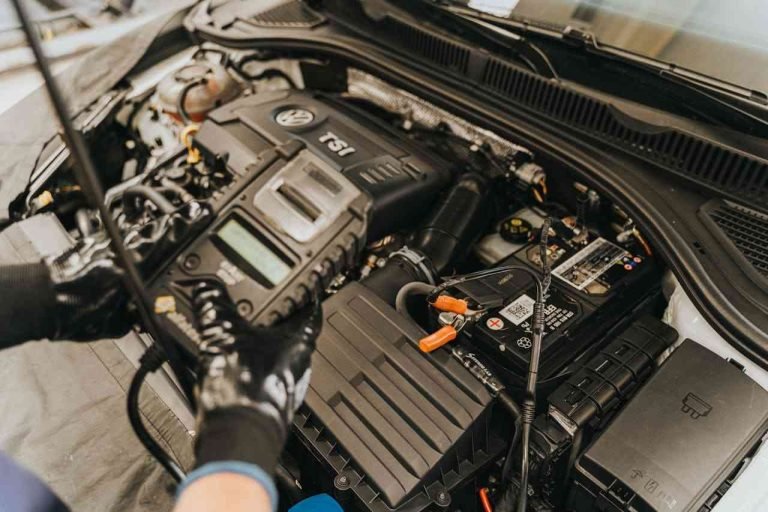 Why Genuine Toyota Car Parts Ensure Longevity and Performance Mechanic inspecting a car engine using genuine Toyota car parts to ensure optimal performance and durability.