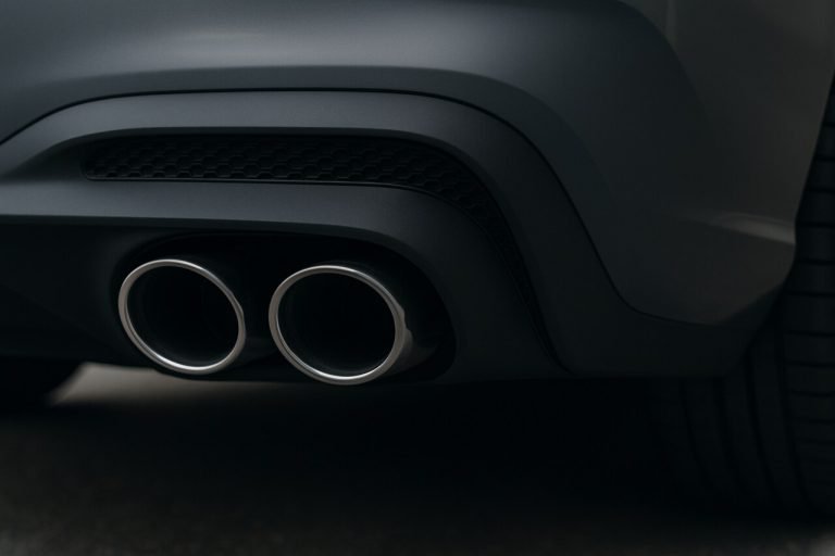 Close-up of modern dual exhaust system on a sleek performance car.