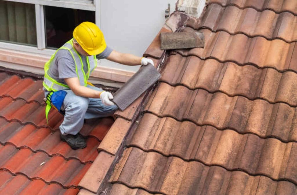 Worker replacing roof tiles on an Ohio home