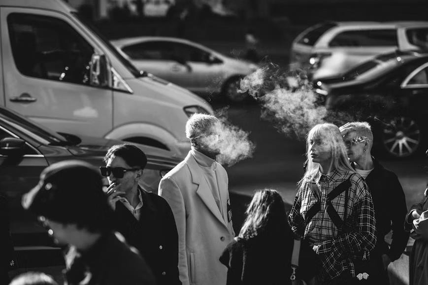 How Full Cigarettes Influence Social Interactions and Norm People smoking full cigarettes on a busy street, interacting casually.