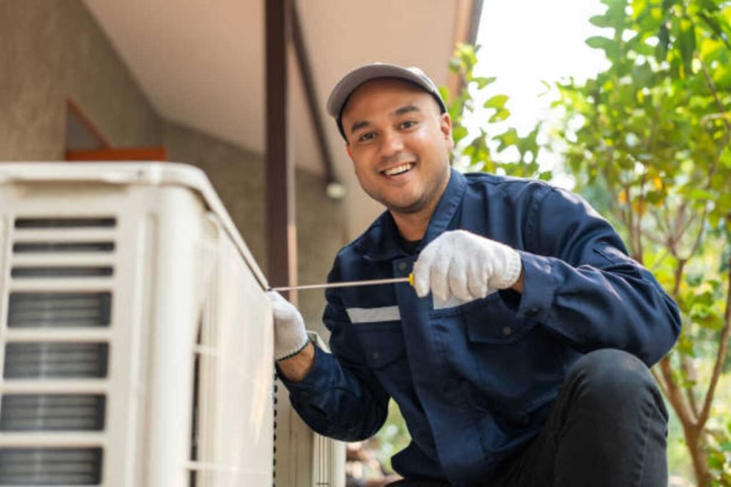 HVAC technician servicing outdoor AC unit