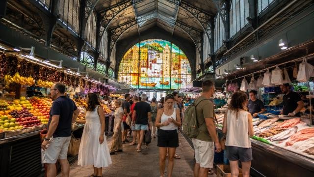 Mercado Central de Atarazanas Málaga with fruit stalls, seafood counters, and stained-glass window