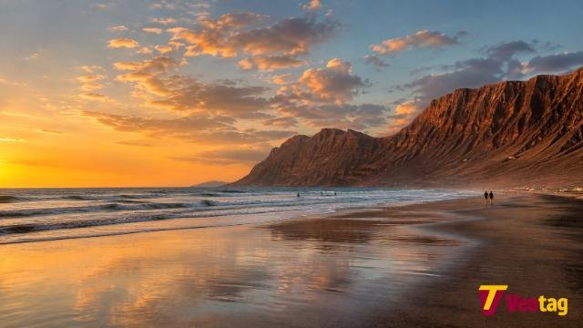Playa de Famara Lanzarote beach and Risco de Famara cliffs at sunset
