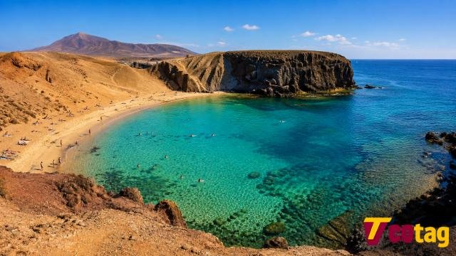 Playa de Papagayo beach in Lanzarote with turquoise water and volcanic cliffs