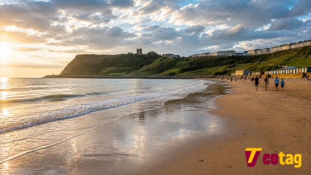 Scarborough North Bay beach in North Yorkshire with castle headland and colourful beach huts