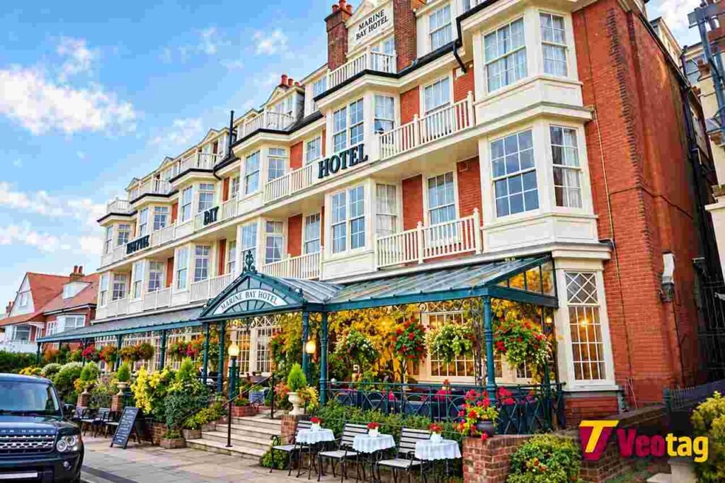 Walpole Bay Hotel in Margate featuring historic red-brick architecture and a flower-filled entrance