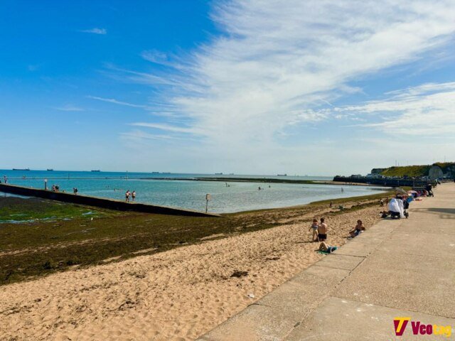 Walpole Bay and the tidal pool with sandy beach, calm seawater, swimmers, and visitors enjoying a sunny day.